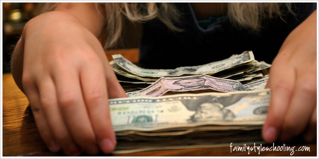 teaching kids to save for a trip counting money